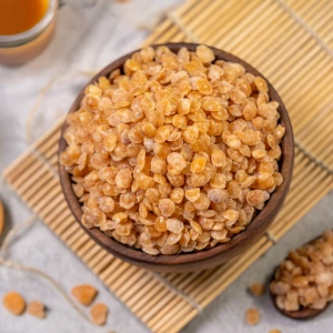 A wooden bowl filled with Cone Crackles, flat caramelised nut pieces used as toppings for ice cream and premium desserts.