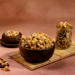 A wooden bowl filled with Mix Nut Crunch, a blend of almonds, cashews and pistachios used as toppings for ice cream and premium desserts.