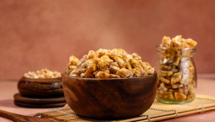 Mix nuts 2 A wooden bowl filled with Mix Nut Crunch, a blend of almonds, cashews and pistachios used as toppings for ice cream and premium desserts.