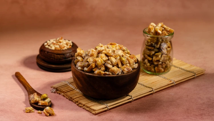 Mix nuts 3 A wooden bowl filled with Mix Nut Crunch, a blend of almonds, cashews and pistachios used as toppings for ice cream and premium desserts.