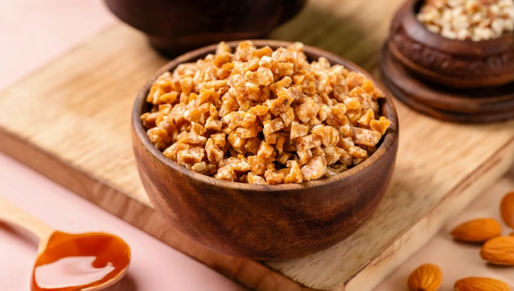 Sprinkeles 2 A wooden bowl filled with nutty Sprinkles, crunchy pieces used as toppings for ice cream and premium desserts.