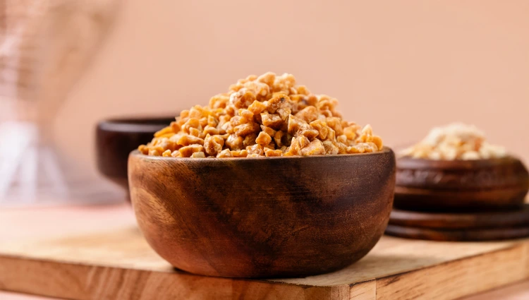 Sprinkeles 3 A wooden bowl filled with nutty Sprinkles, crunchy pieces used as toppings for ice cream and premium desserts.