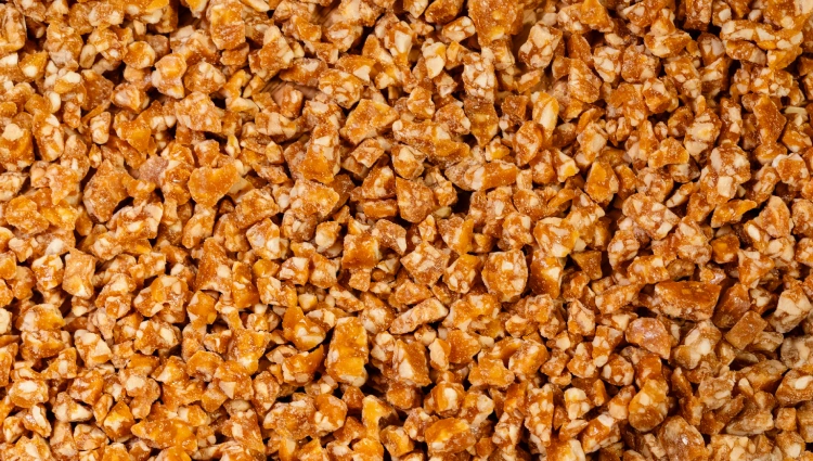 Sprinkels 1 A wooden bowl filled with nutty Sprinkles, crunchy pieces used as toppings for ice cream and premium desserts.